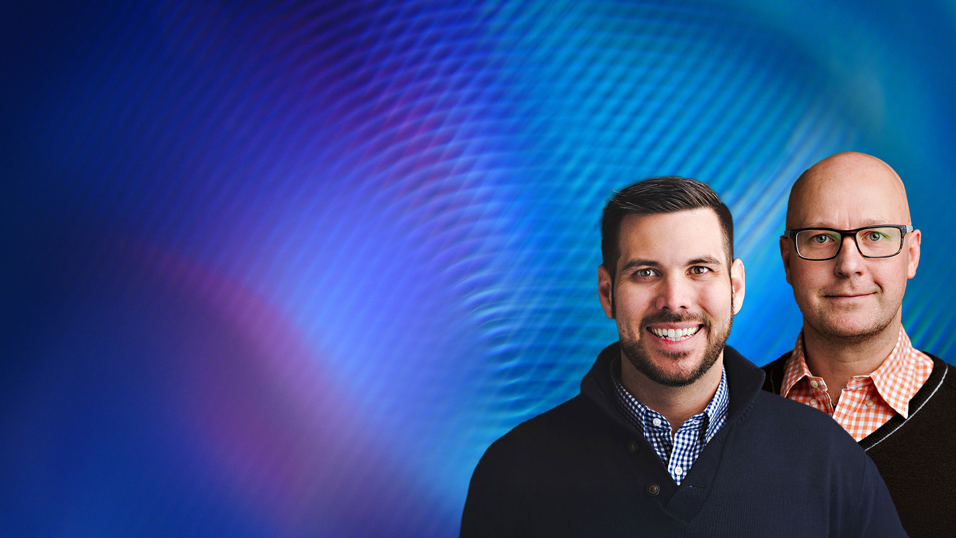 Michael and Rob in front of a color background