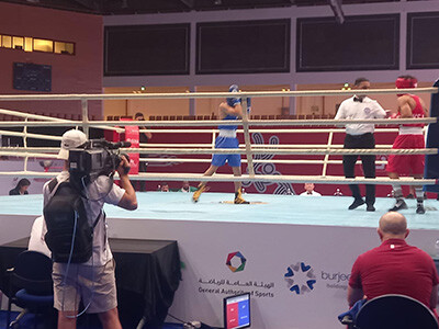 Camera operator recording a boxing match