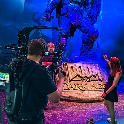DOOM The Dark Age booth with a Doom Slayer statue