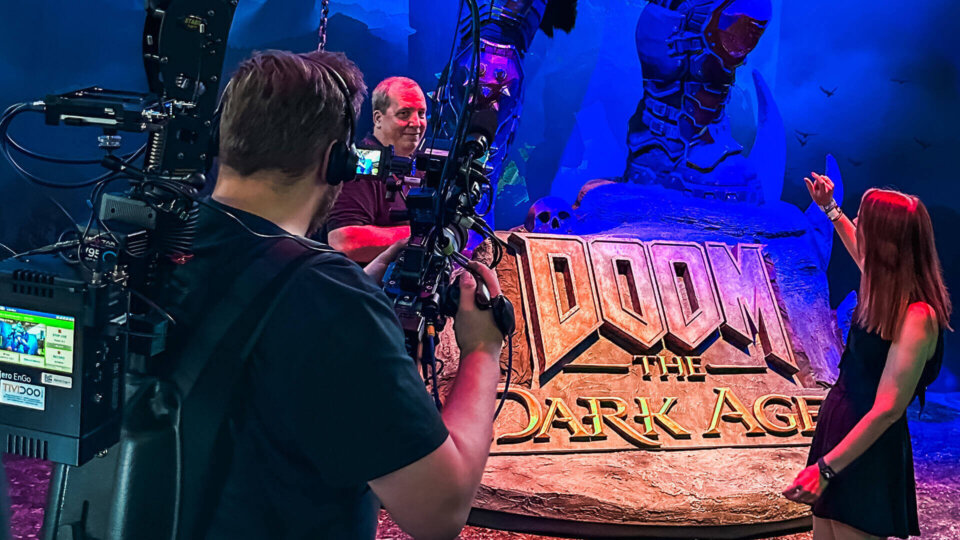 DOOM The Dark Age booth with a Doom Slayer statue