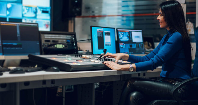 Woman using equipment in control room