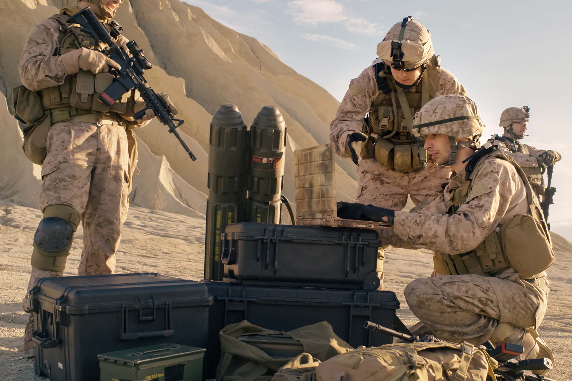 Military members looking at a laptop