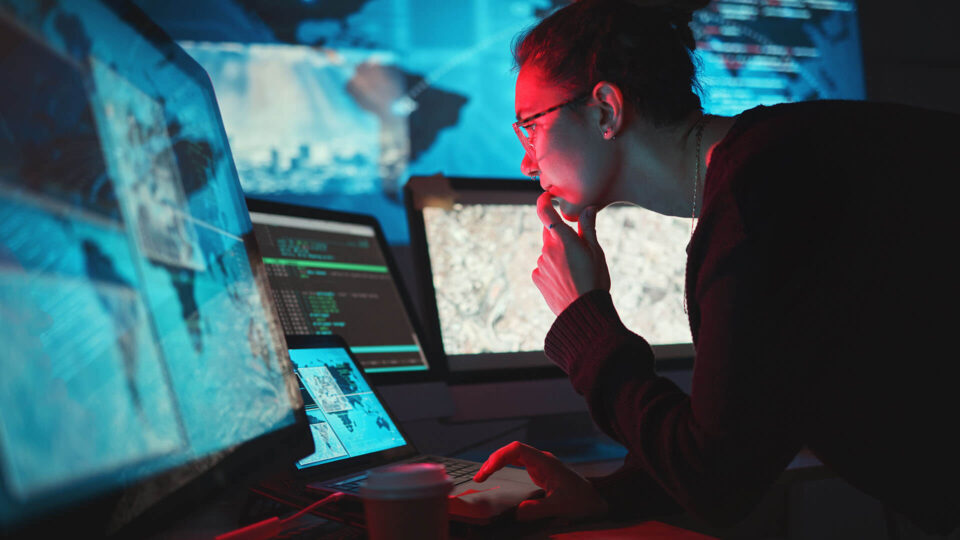 Woman looking at computer screen thinking