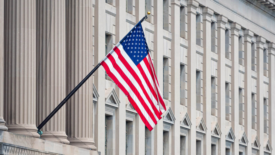 American flag on the facade of a historic building