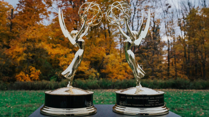 Emmy statues in front of leaves