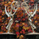 Emmy statues in front of leaves