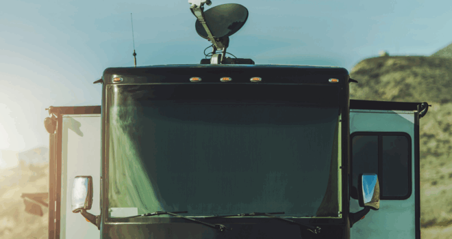 Class A Diesel Pusher with On Roof Satellite TV Dish Installed. Watching Television While on a Road.