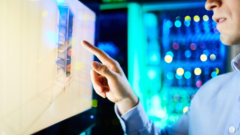 Close-up of man pointing at screen