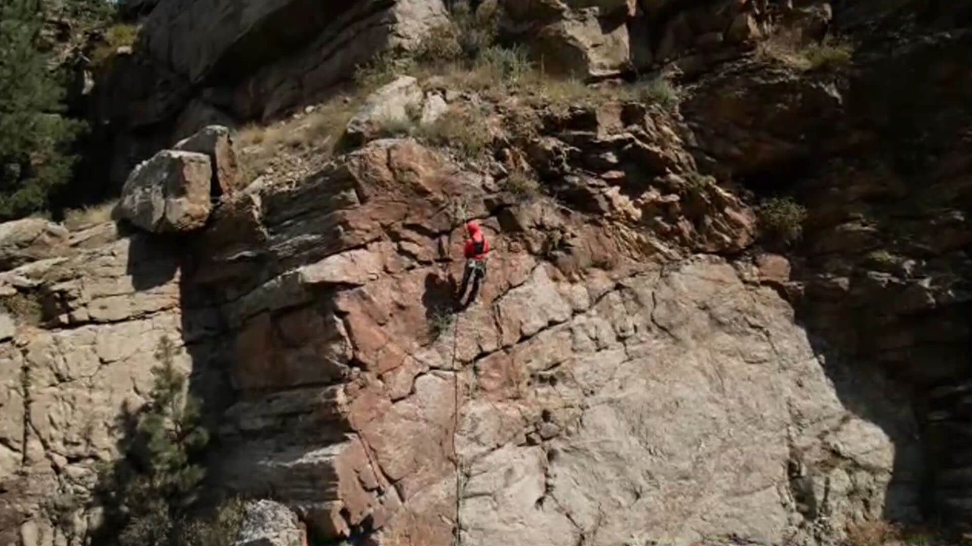 Kevin repelling down the cliff