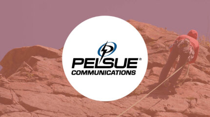 Kevin Karn, 30-year climbing veteran, rappelling down with the Pelsue logo