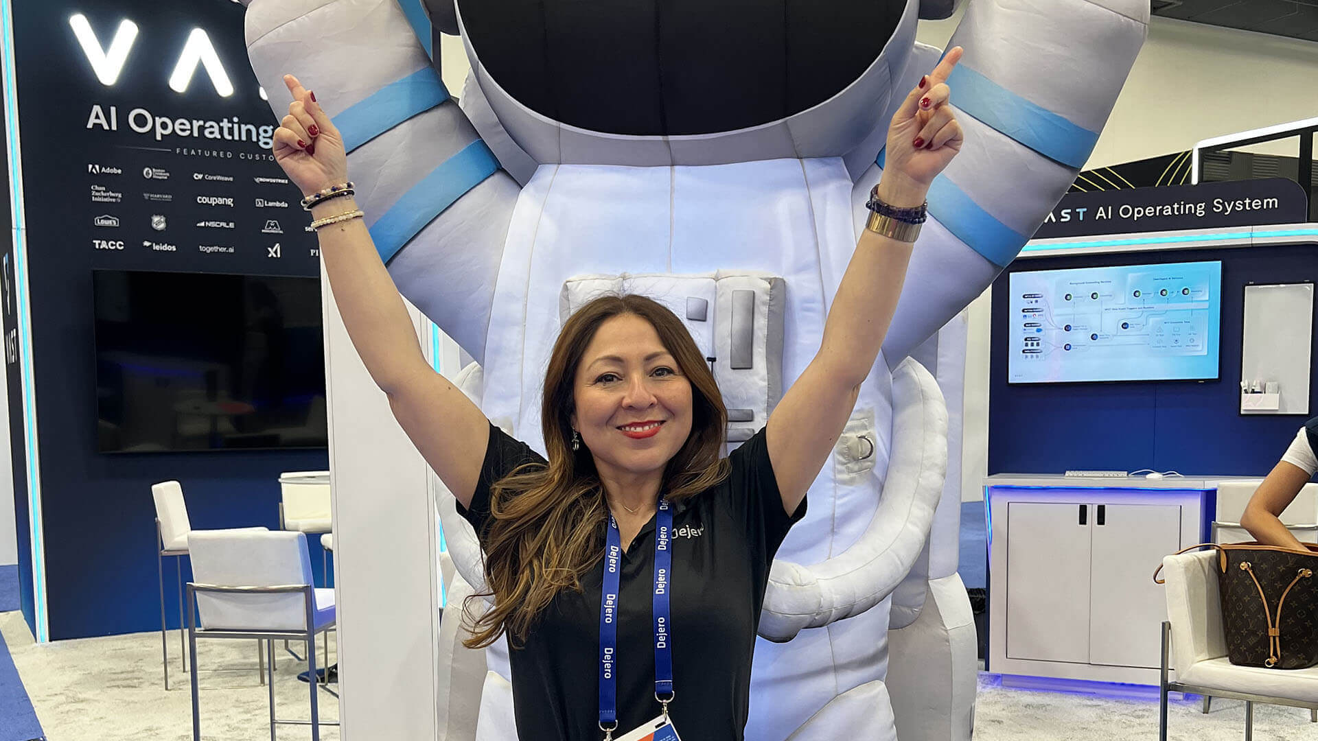 Ivy Cuervo in front of an astronaut statue pointing up