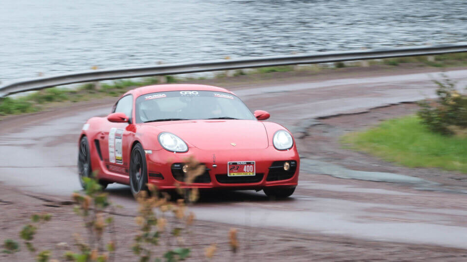 Porsche at a fast speed taking a turn, photographed by Larry Strung